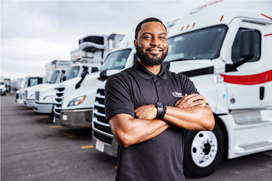 Dedicated transportation driver in front of trucks